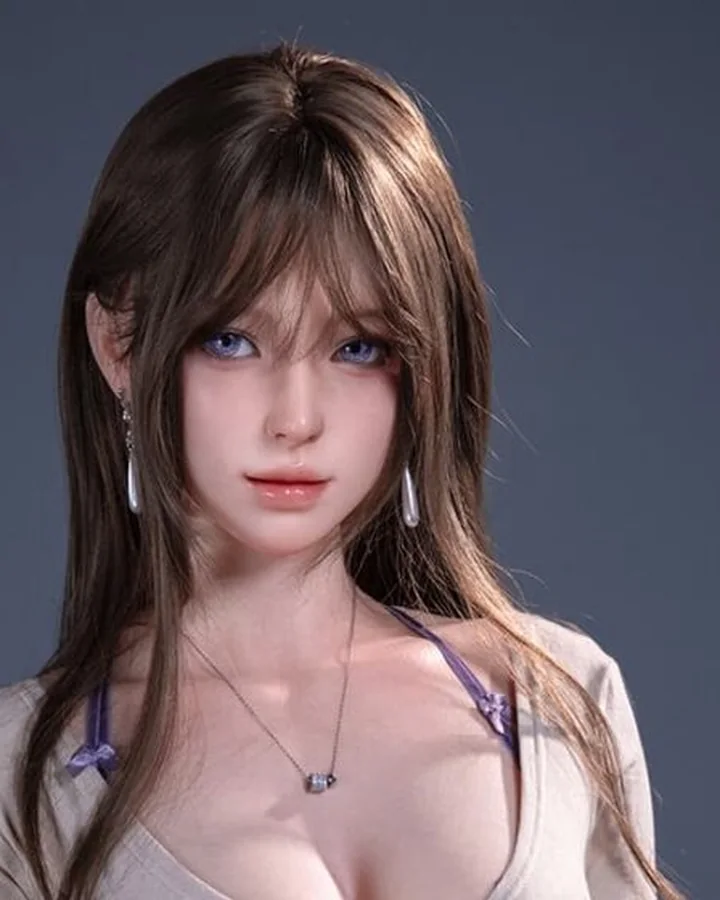 Doll with long brown hair in a gray wrap top